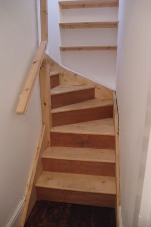 Bespoke timber staircase and fitted shelves from 1st to 2nd floor