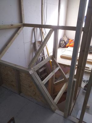 Formation of storage cupboards, maximising space over staircase