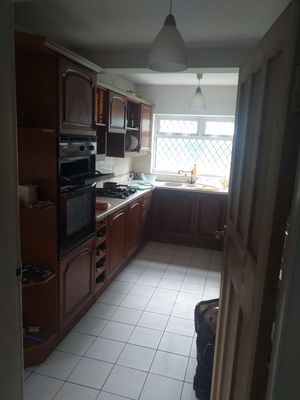 Original kitchen next to a separate utility room