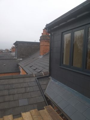 Finished dormer, clad in composite roof tiles with lead flashing